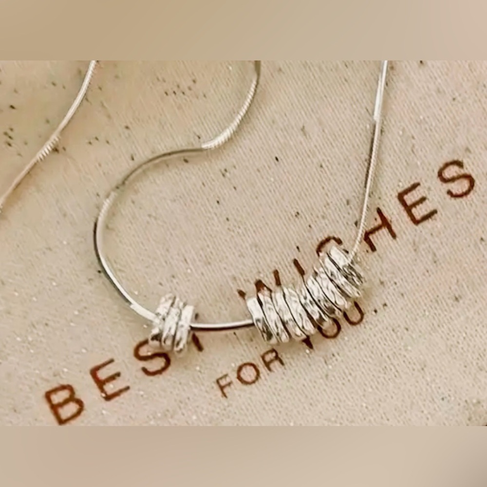 Elegant Silver Necklace with Textured Rings